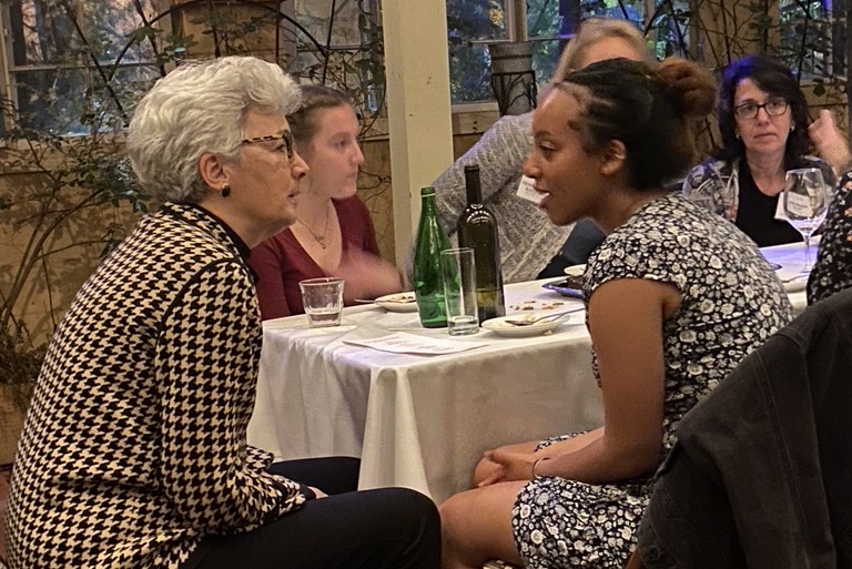 A picture of Elizabeth Harden with WIN Scholar Rebecca Melaku at a dinner table